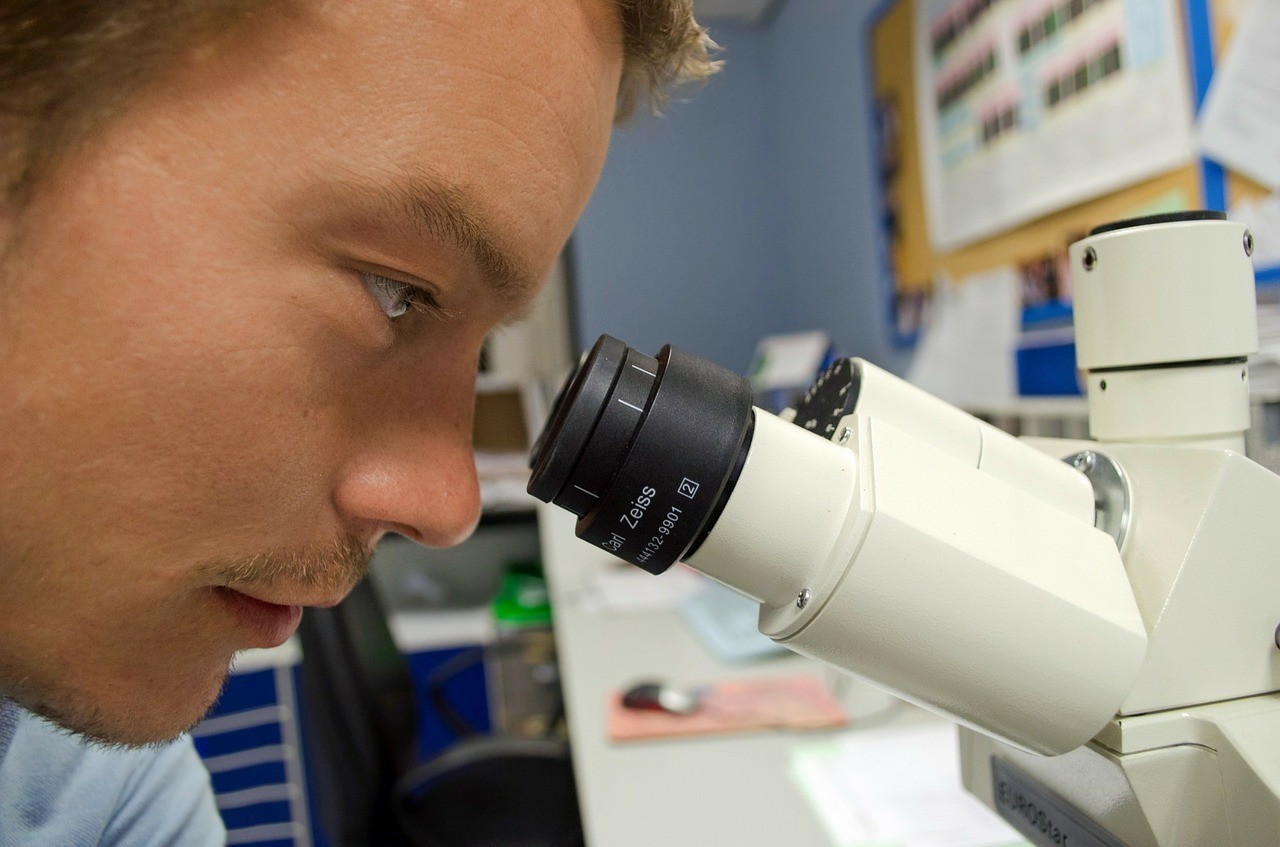 Person looking into a microscope